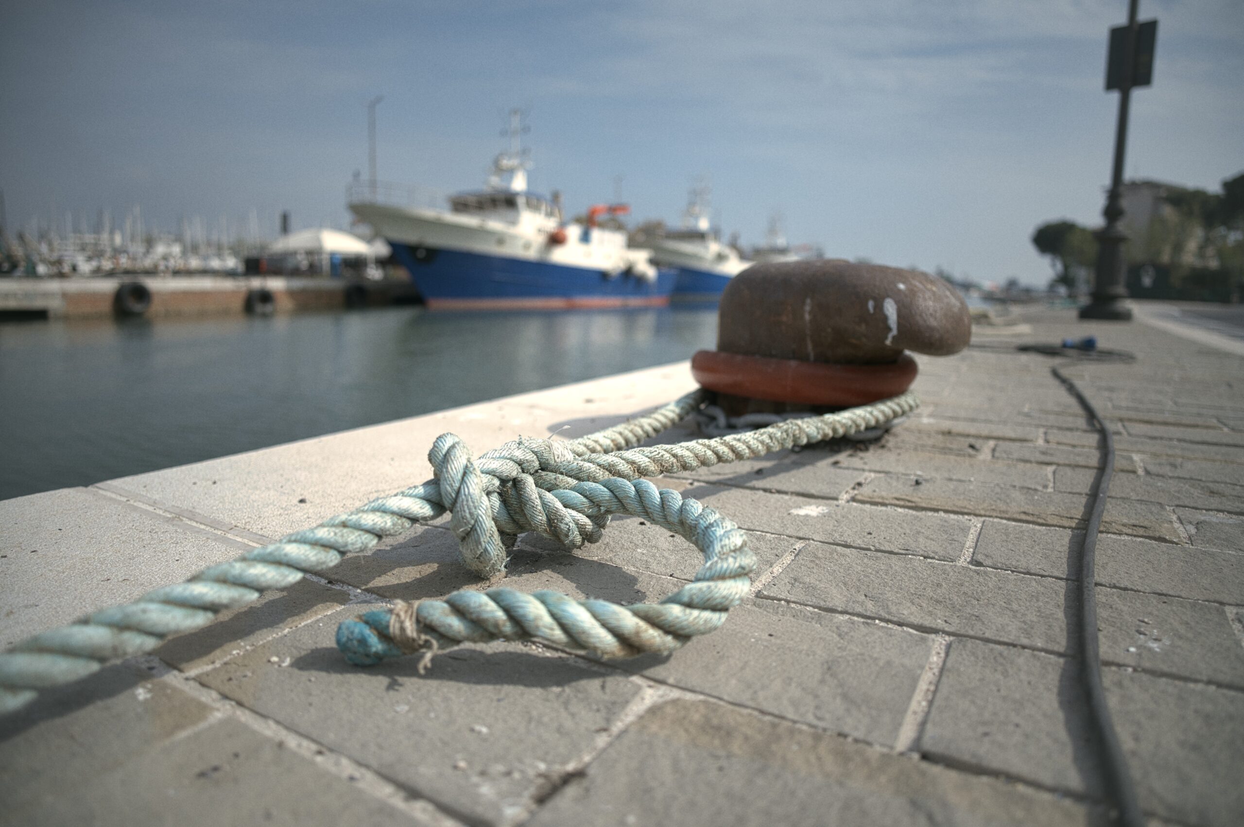 dock-of-a-harbor-with-a-tied-rope-of-a-boat